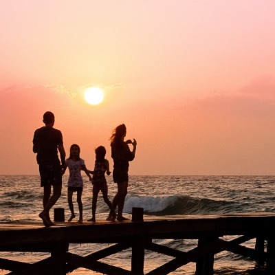 Family on dock in sunset